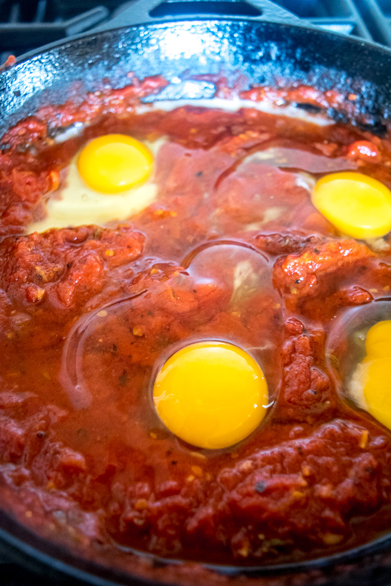 Eggs in purgatory-eggs are poached in a lip-smacking fiery tomato sauce that is meant to sopped up with a hunky slice of bread. |www.cookeatlaugh.com