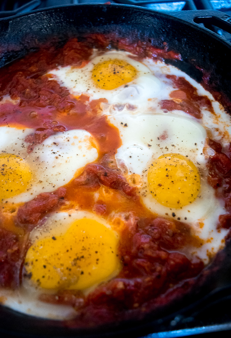 Eggs in purgatory-eggs are poached in a lip-smacking fiery tomato sauce that is meant to sopped up with a hunky slice of bread. |www.cookeatlaugh.com