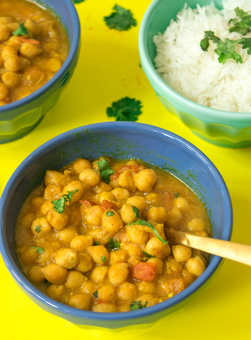 One pot chickpea stew (Indian Chana curry)--cooked in a rich tomato onion gravy that is spiced with cumin, coriander, turmeric, garam masala, and chili powder. |www.cookeatlaugh.com