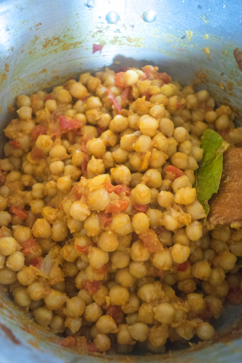 One pot chickpea stew (Indian Chana curry)--cooked in a rich tomato onion gravy that is spiced with cumin, coriander, turmeric, garam masala, and chili powder. |www.cookeatlaugh.com