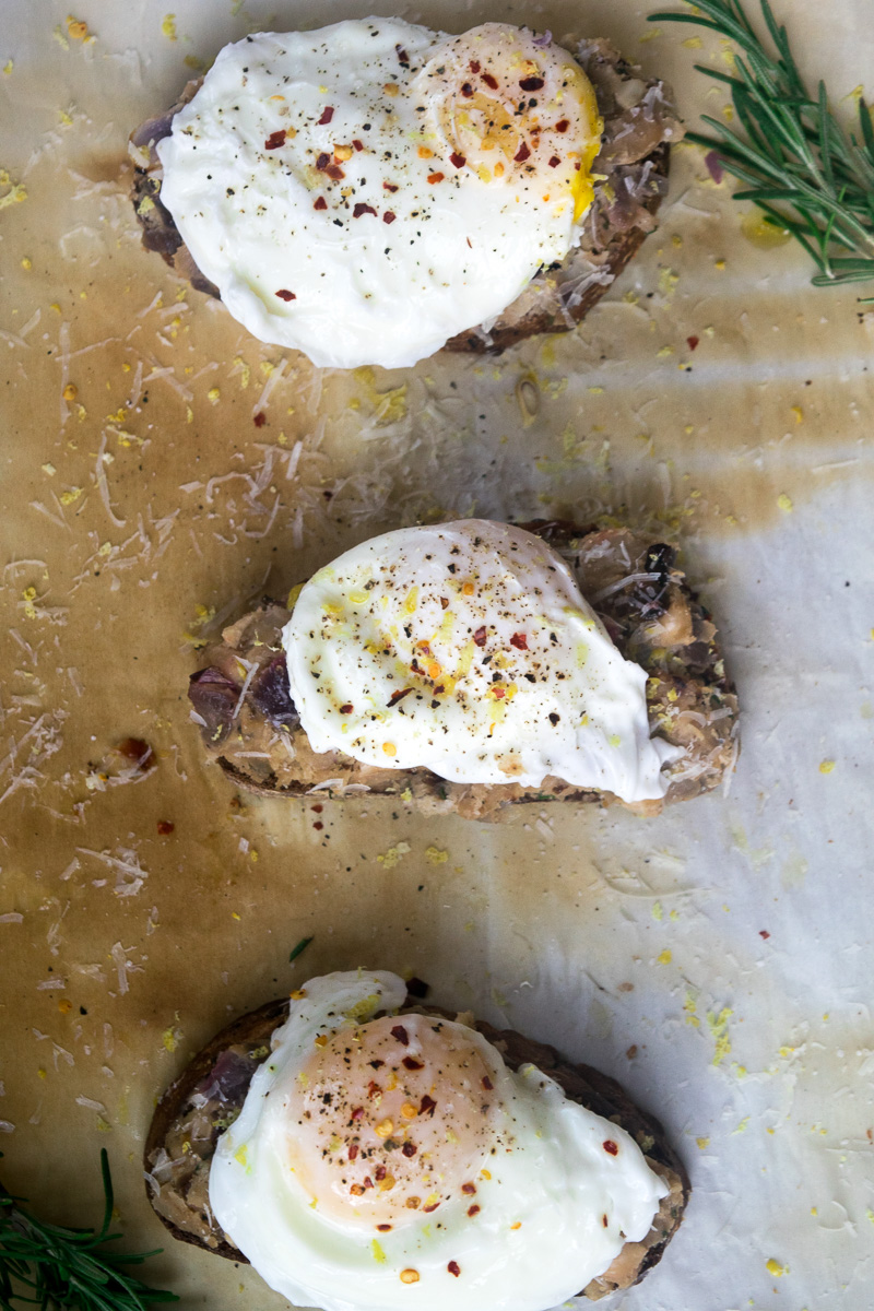 Smashed beans on toast with poached egg--Canned white beans tossed with spices, smashed on toast, topped with a perfeclty poached egg. |www.cookeatlaugh.com